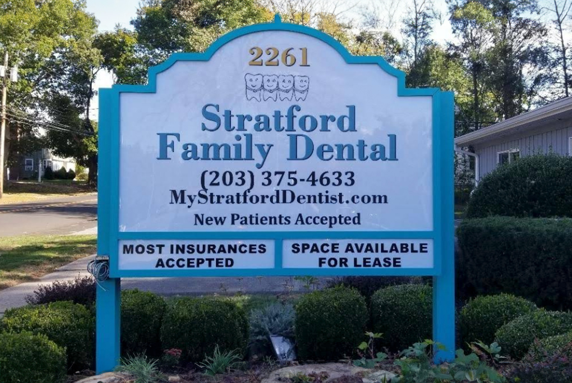 The image shows a sign for  Stratford Family Dental  with contact information displayed beneath the name.