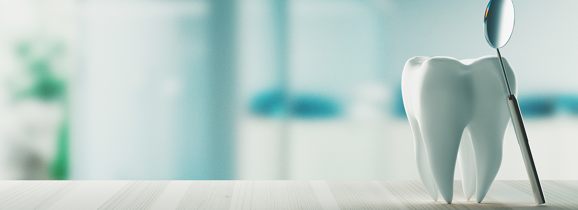 The image shows a toothbrush with bristles against a blurred background, which appears to be an interior space with light-colored walls and a blueish hue.
